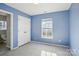 This bedroom features light blue walls, a window and a closet for ample storage space at 10430 Samuels Way Dr, Huntersville, NC 28078