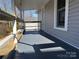 Gray back porch with wooden railings and view of backyard at 107 Meadow Ne Ave # 7, Concord, NC 28025