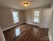 Bright bedroom with hardwood floors and two windows at 107 Meadow Ne Ave # 7, Concord, NC 28025