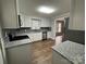 Updated kitchen, featuring white cabinets and granite countertops at 107 Meadow Ne Ave # 7, Concord, NC 28025