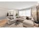 Living room with sectional sofa and large windows at 12307 Bluestem Ln, Charlotte, NC 28277