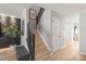 Modern staircase with dark wood railing and geometric wall at 12307 Bluestem Ln, Charlotte, NC 28277