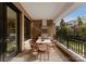 Outdoor balcony featuring an outdoor kitchen with a stainless steel grill and dining area at 130 Cherokee Rd # 104, Charlotte, NC 28207
