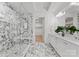 Marble bathroom featuring a glass-enclosed shower and dual vanity sinks at 130 Cherokee Rd # 104, Charlotte, NC 28207