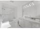 Bright bathroom featuring glass shower, gray vanity, and sleek modern finishes at 130 Cherokee Rd # 104, Charlotte, NC 28207