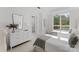 Bedroom featuring two beds, a large window, and modern decor at 130 Cherokee Rd # 104, Charlotte, NC 28207
