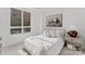 Bedroom featuring a comfortable bed, a large window, and neutral decor at 130 Cherokee Rd # 104, Charlotte, NC 28207