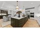 Open-concept kitchen with a large island, stainless steel appliances, and a view to the living area at 130 Cherokee Rd # 104, Charlotte, NC 28207
