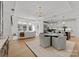 Open-concept living area with hardwood floors, modern lighting, and bright, open space at 130 Cherokee Rd # 104, Charlotte, NC 28207