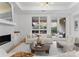 Cozy living room with a fireplace, large windows, and comfortable seating at 130 Cherokee Rd # 104, Charlotte, NC 28207