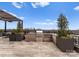 Outdoor kitchen on a rooftop terrace offers a grill and counter space for cooking and entertaining at 130 Cherokee Rd # 104, Charlotte, NC 28207