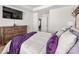 A cozy bedroom featuring a television, soft pillows, and a plush purple throw blanket at 1342 Galloway Rd # 132, Charlotte, NC 28262