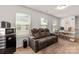 Bonus room featuring comfortable seating and a desk area with three windows for natural light at 1342 Galloway Rd # 132, Charlotte, NC 28262