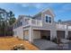 Two-story home exterior featuring a two-car garage, covered parking, and a small balcony at 1342 Galloway Rd # 132, Charlotte, NC 28262