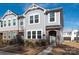 Charming two-story townhome featuring stone accents and a well-maintained lawn on a sunny day at 1342 Galloway Rd # 132, Charlotte, NC 28262