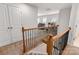 View of hallway with carpeted stairs and natural wood railing at 1342 Galloway Rd # 132, Charlotte, NC 28262