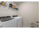 Laundry room showcasing modern, front-loading washer and dryer with wire rack shelving at 1342 Galloway Rd # 132, Charlotte, NC 28262