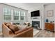 Bright living room with a fireplace, large windows, and comfortable leather sofa at 1342 Galloway Rd # 132, Charlotte, NC 28262