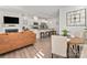 Bright, open-concept living room and kitchen with stainless steel appliances, granite countertops, and hardwood floors at 1342 Galloway Rd # 132, Charlotte, NC 28262