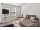 Living room with a comfortable sectional sofa, ottoman, and natural light from two windows at 1342 Galloway Rd # 132, Charlotte, NC 28262
