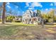 Two-story home with blue siding, wraparound porch, and landscaped yard at 213 N Congress St, York, SC 29745