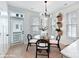 Bright dining area with glass table and modern light fixture at 2327 Rozzelles Ferry Rd # 26, Charlotte, NC 28208