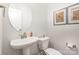 Small half bathroom with pedestal sink and toilet at 2517 Lydia Ave, Charlotte, NC 28205