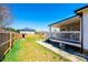 Backyard showcasing a covered deck, fenced yard, and lush green grass at 300 Pine Meadows Cir, Hickory, NC 28601