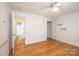 Bedroom with hardwood floors, ceiling fan, and ensuite bathroom access at 300 Pine Meadows Cir, Hickory, NC 28601