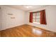 Comfortable bedroom featuring hardwood floors and a window with blinds, creating a cozy atmosphere at 300 Pine Meadows Cir, Hickory, NC 28601