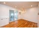 Light dining room with hardwood floors, slider to sunroom, and decorative hanging pendant at 300 Pine Meadows Cir, Hickory, NC 28601