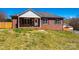 Charming brick home featuring a cozy front porch with classic shutters and a well-manicured lawn at 300 Pine Meadows Cir, Hickory, NC 28601