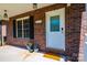 Welcoming front porch entrance of brick home, featuring a decorative glass front door and manicured flower pots at 300 Pine Meadows Cir, Hickory, NC 28601