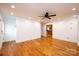 Open-concept living room with hardwood floors, modern lighting, and views into the kitchen at 300 Pine Meadows Cir, Hickory, NC 28601