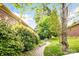 Beautifully landscaped backyard with winding brick path and mature shade trees at 3024 Kern Dr, Salisbury, NC 28147