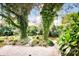 Serene backyard featuring lush greenery and a stone patio, creating a private oasis at 3024 Kern Dr, Salisbury, NC 28147