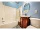 Cozy bathroom features a combined tub and shower, vanity with storage, and blue walls at 3024 Kern Dr, Salisbury, NC 28147