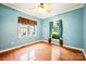 Bedroom with hardwood floors, light blue walls, crown molding, and windows with neutral and patterned curtains at 3024 Kern Dr, Salisbury, NC 28147