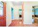 Hallway features hardwood floors, neutral walls with red trim, and doorways leading to the bathroom and bedroom at 3024 Kern Dr, Salisbury, NC 28147
