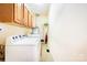 Bright laundry room with modern white washer and dryer and natural wood cabinetry at 3024 Kern Dr, Salisbury, NC 28147
