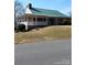 One-story community clubhouse with green metal roof at 318 Chapel Hill Rd # 695, Troy, NC 27371