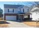 Two-story house with gray siding, brick accents, and a double-car garage at 3831 Larkhaven Village Dr, Charlotte, NC 28215