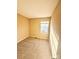 Well-lit bedroom featuring carpet flooring and a window at 3959 Briarhill Dr, Charlotte, NC 28215