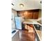 White appliances and wood cabinets in this kitchen at 3959 Briarhill Dr, Charlotte, NC 28215