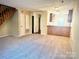 Living room with carpeted floors and wooden staircase at 3959 Briarhill Dr, Charlotte, NC 28215