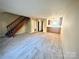 Living room with carpeted floors and wooden staircase at 3959 Briarhill Dr, Charlotte, NC 28215