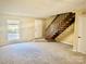 Spacious living room with carpeted floors and wooden staircase at 3959 Briarhill Dr, Charlotte, NC 28215