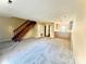 Living room with carpeted floors and wooden staircase at 3959 Briarhill Dr, Charlotte, NC 28215