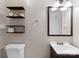 Clean bathroom with shelving for storage, vanity and mirror at 443 Picadilly Ln, Troutman, NC 28166