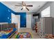 Bright bedroom features a ceiling fan, TV, and fun, colorful decor at 443 Picadilly Ln, Troutman, NC 28166